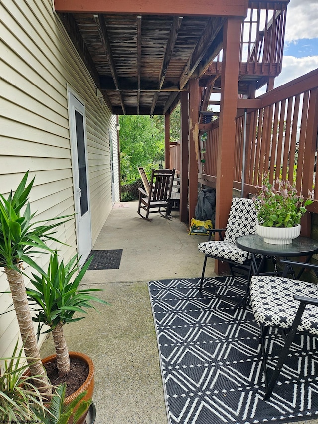 view of patio with outdoor dining area and fence