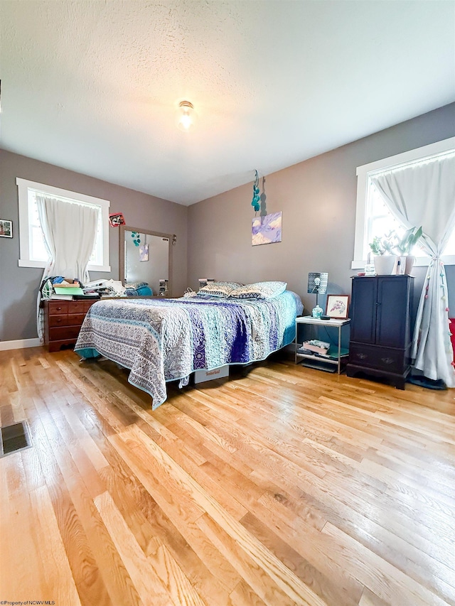 96 Long St, Hambleton, WV 26269 - bedroom featuring light wood-type flooring, a textured ceiling, and baseboards