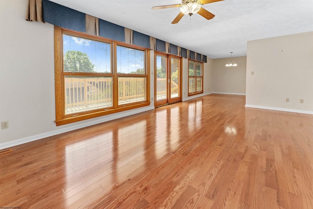 6 Ridge Pl, Morgantown, WV 26505 - unfurnished living room with ceiling fan, a chandelier, baseboards, and light wood finished floors