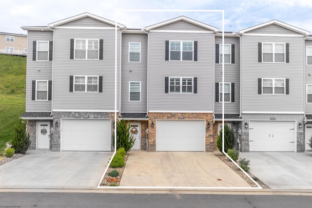 2052 Mountain Ash Ln, Morgantown, WV 26501 - view of property with an attached garage, stone siding, and driveway