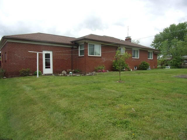 201 Findley St, Elkins, WV 26241 - view of side of property featuring brick siding, a yard, and a chimney