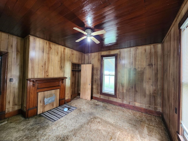 580 Deer Haven Dr, Lost Creek, WV 26385 - unfurnished living room featuring wood ceiling, carpet flooring, wooden walls, a ceiling fan, and baseboards