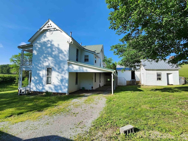 580 Deer Haven Dr, Lost Creek, WV 26385 - back of house with a lawn, a balcony, metal roof, an outbuilding, and entry steps