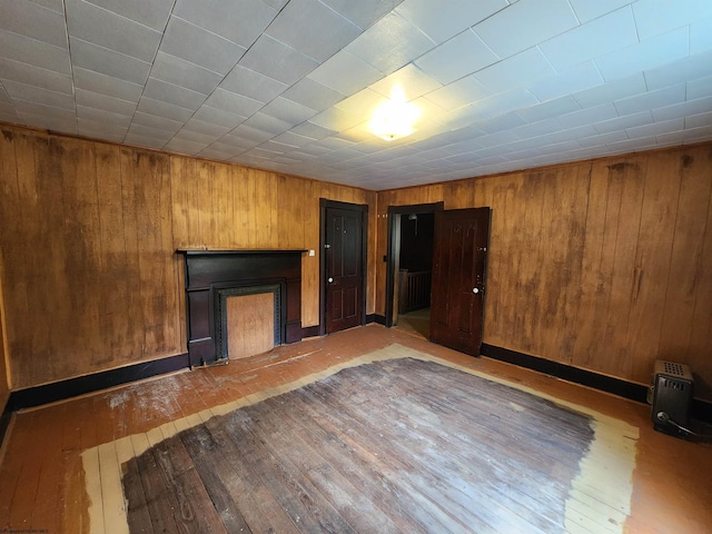 580 Deer Haven Dr, Lost Creek, WV 26385 - unfurnished living room featuring hardwood / wood-style flooring, wooden walls, and a fireplace