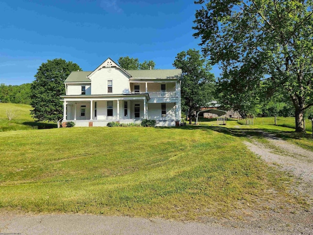 580 Deer Haven Dr, Lost Creek, WV 26385 - victorian-style house featuring a porch, a detached carport, driveway, a front yard, and metal roof