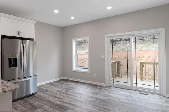 111 Frisco Ln, Bridgeport, WV 26330 - kitchen with stainless steel refrigerator with ice dispenser, white cabinets, wood finished floors, recessed lighting, and baseboards