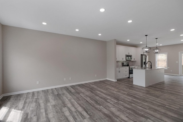 111 Frisco Ln, Bridgeport, WV 26330 - unfurnished living room with dark wood-style flooring, baseboards, recessed lighting, and a sink