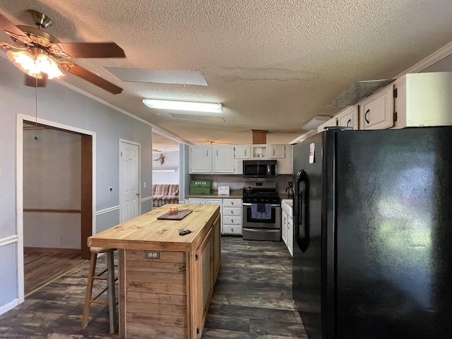 564 Big Run Rd, Napier, WV 26631 - kitchen featuring appliances with stainless steel finishes, butcher block counters, a textured ceiling, ornamental molding, and white cabinetry