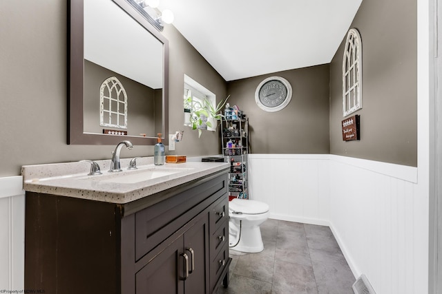 719 Elk Run Rd, Bruceton Mills, WV 26525 - bathroom with a wainscoted wall, vanity, toilet, and a decorative wall
