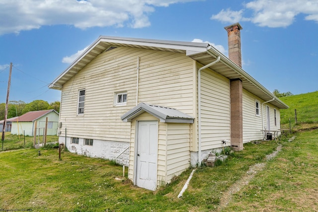 719 Elk Run Rd, Bruceton Mills, WV 26525 - rear view of house featuring a chimney and a yard
