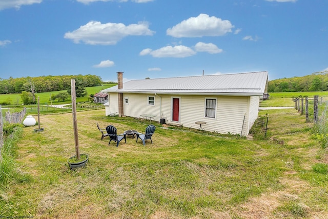 719 Elk Run Rd, Bruceton Mills, WV 26525 - back of property with a fire pit, a chimney, and metal roof
