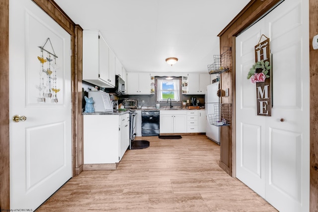 719 Elk Run Rd, Bruceton Mills, WV 26525 - kitchen featuring a sink, black dishwasher, freestanding refrigerator, white cabinets, and light wood-style floors
