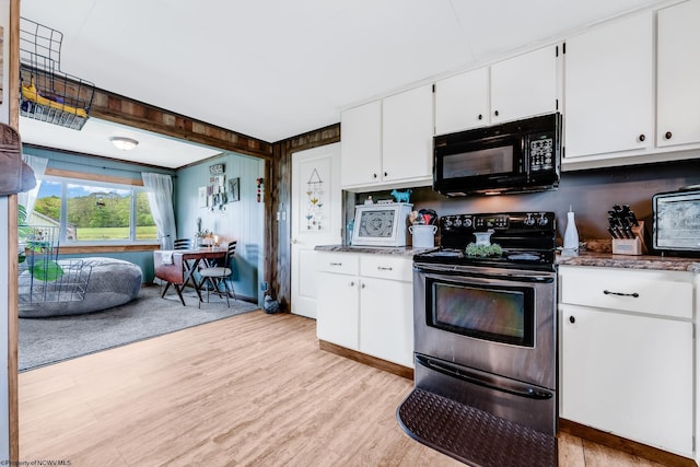 719 Elk Run Rd, Bruceton Mills, WV 26525 - kitchen featuring black microwave, stainless steel electric stove, light wood-style floors, white cabinets, and dark stone countertops