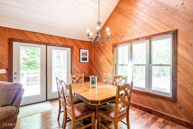 434 Cabin Mountain Rd, Davis, WV 26260 - dining space featuring lofted ceiling, a chandelier, wood walls, and light wood finished floors
