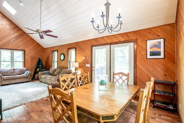 434 Cabin Mountain Rd, Davis, WV 26260 - dining space with lofted ceiling, wood walls, wood-type flooring, a chandelier, and a ceiling fan