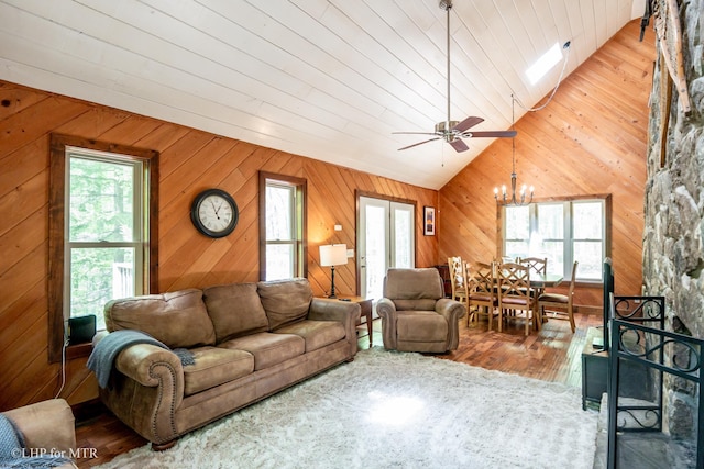 434 Cabin Mountain Rd, Davis, WV 26260 - living area featuring lofted ceiling, a chandelier, wood finished floors, wooden walls, and ceiling fan