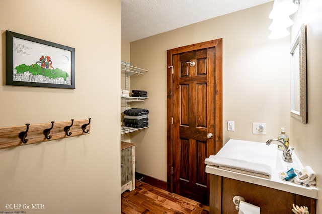 434 Cabin Mountain Rd, Davis, WV 26260 - bathroom with wood finished floors, vanity, and a textured ceiling