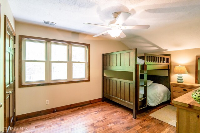 434 Cabin Mountain Rd, Davis, WV 26260 - bedroom featuring wood finished floors, baseboards, lofted ceiling, a ceiling fan, and a textured ceiling