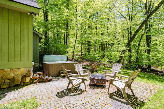 434 Cabin Mountain Rd, Davis, WV 26260 - view of patio with a hot tub, a fire pit, and a wooded view
