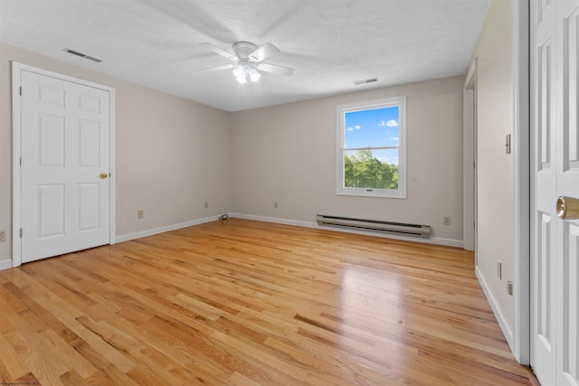 42 Ice Linn Ln, Fairmont, WV 26554 - unfurnished bedroom with baseboard heating, light wood-style floors, baseboards, a textured ceiling, and ceiling fan