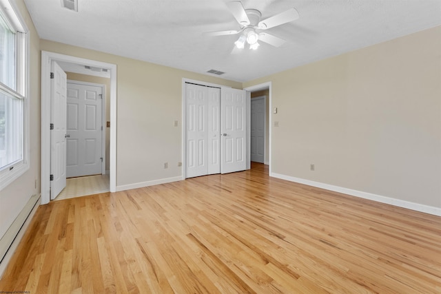 42 Ice Linn Ln, Fairmont, WV 26554 - unfurnished bedroom with a baseboard radiator, light wood-style floors, baseboards, and a ceiling fan
