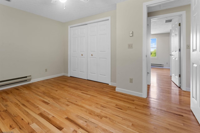 42 Ice Linn Ln, Fairmont, WV 26554 - unfurnished bedroom with light wood finished floors, a baseboard radiator, baseboards, and a closet