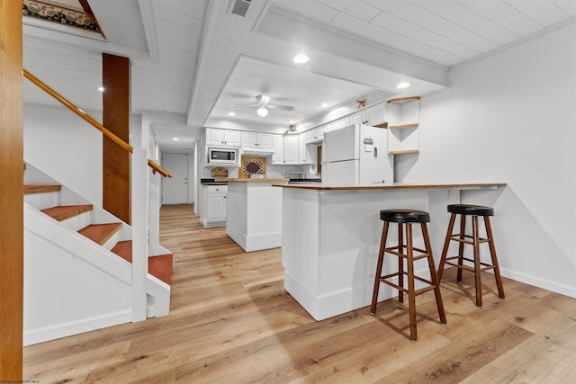42 Ice Linn Ln, Fairmont, WV 26554 - kitchen featuring freestanding refrigerator, built in microwave, a peninsula, ceiling fan, and white cabinetry