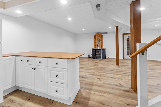 42 Ice Linn Ln, Fairmont, WV 26554 - kitchen featuring a wood stove, white cabinets, light wood-style floors, recessed lighting, and a peninsula