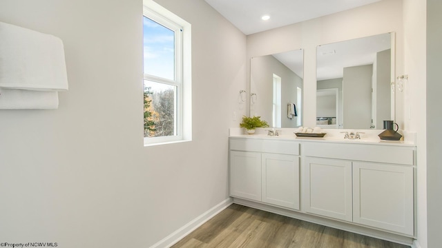 819 Bogey Ln, Maidsville, WV 26541 - bathroom with wood finished floors, baseboards, and double vanity