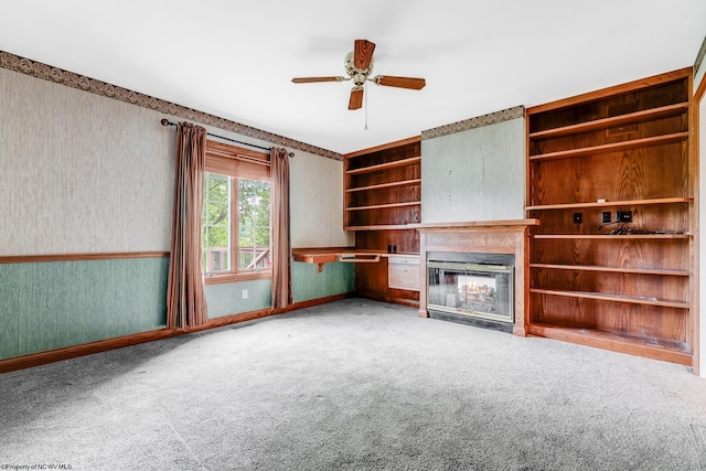 2022 Georgian Ln, Morgantown, WV 26508 - unfurnished living room with a glass covered fireplace, carpet flooring, ceiling fan, wallpapered walls, and baseboards
