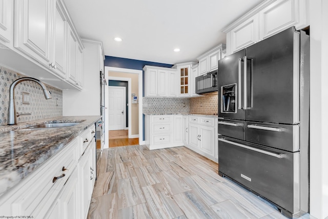 2022 Georgian Ln, Morgantown, WV 26508 - kitchen featuring black appliances, a sink, stone countertops, white cabinetry, and tasteful backsplash