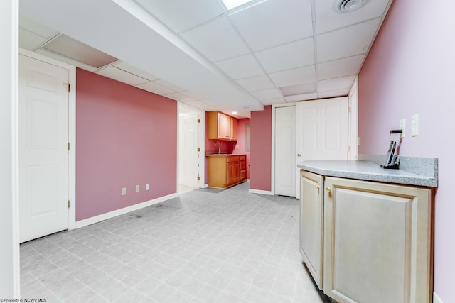 2022 Georgian Ln, Morgantown, WV 26508 - kitchen with a paneled ceiling, a sink, baseboards, light countertops, and light flooring