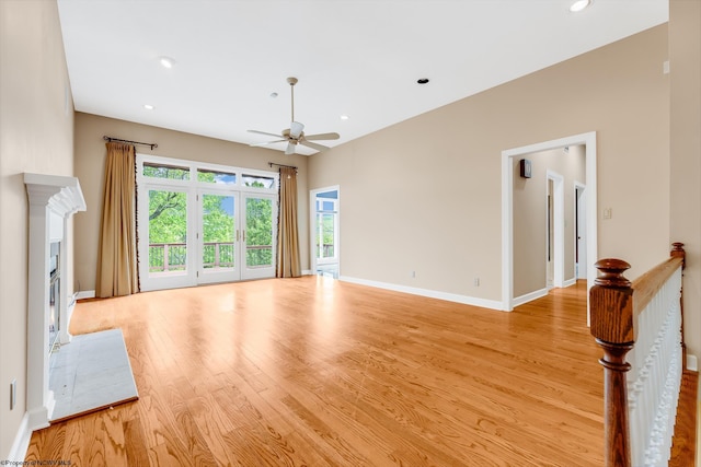 2022 Georgian Ln, Morgantown, WV 26508 - unfurnished living room with ceiling fan, light wood-type flooring, a glass covered fireplace, baseboards, and recessed lighting