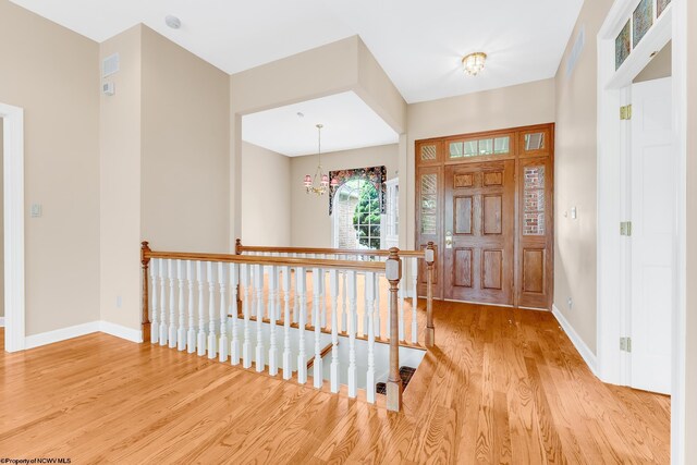 2022 Georgian Ln, Morgantown, WV 26508 - entrance foyer with light wood-type flooring, baseboards, and a chandelier
