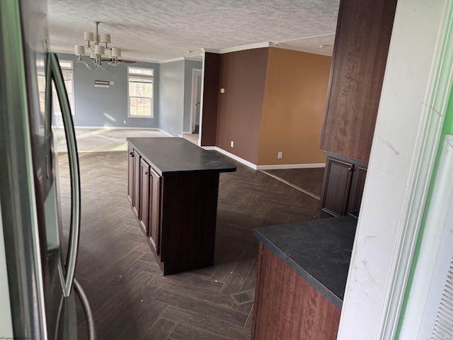 31 Sanctuary Ln, Worthington, WV 26591 - kitchen with freestanding refrigerator, dark countertops, open floor plan, a chandelier, and crown molding