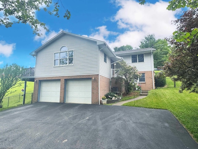 524 Kinney St, Bridgeport, WV 26554 - view of front facade with brick siding, driveway, and a garage