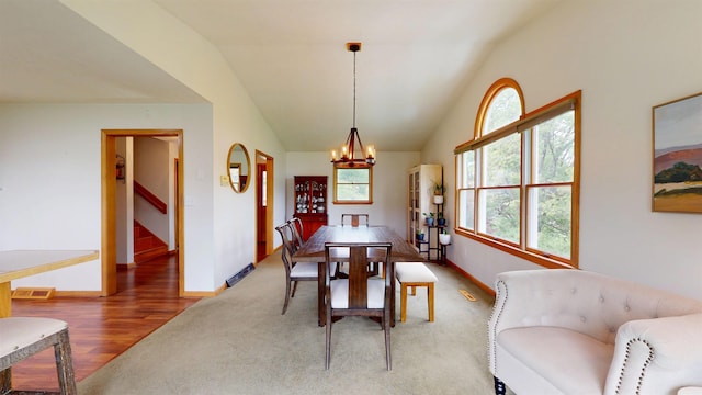 524 Kinney St, Bridgeport, WV 26554 - carpeted dining room with a chandelier, baseboards, stairs, wood finished floors, and vaulted ceiling
