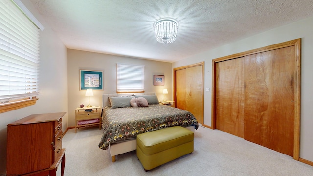524 Kinney St, Bridgeport, WV 26554 - bedroom with multiple closets, light carpet, and a chandelier
