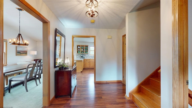524 Kinney St, Bridgeport, WV 26554 - hallway with a chandelier, dark wood-style floors, stairs, and baseboards