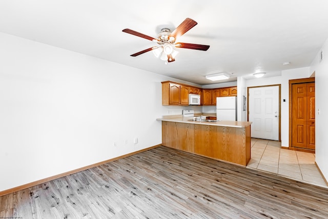 233 Creekside Dr Unit 3, Morgantown, WV 26508 - kitchen with white appliances, a peninsula, light wood-style floors, and ceiling fan