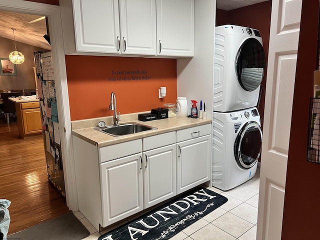 151 Raintree Blvd, Bridgeport, WV 26330 - laundry area with stacked washer / dryer, cabinet space, and light tile patterned floors