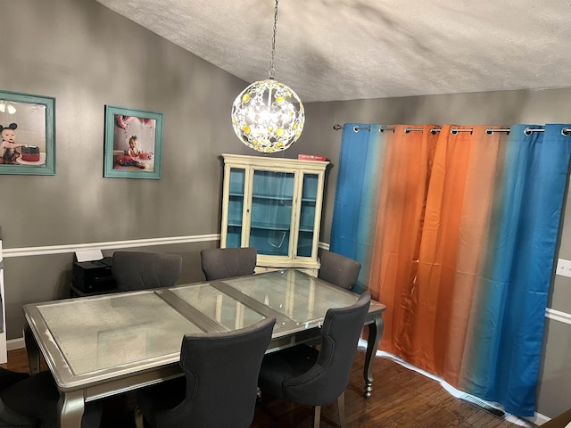 151 Raintree Blvd, Bridgeport, WV 26330 - dining area featuring a chandelier, wood finished floors, and a textured ceiling