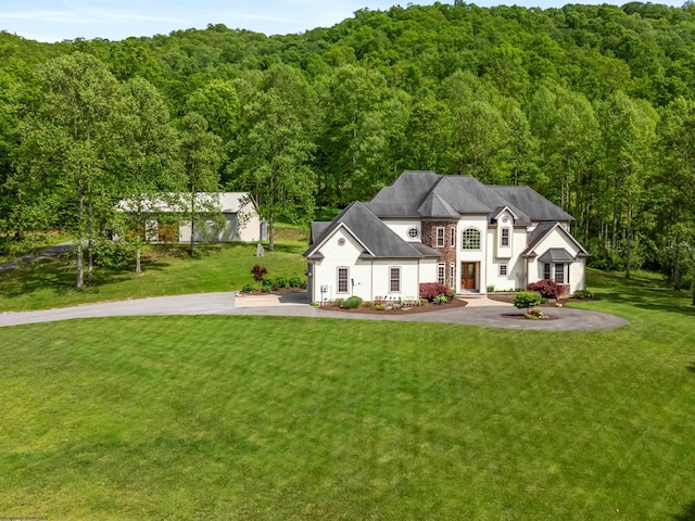 40 Briarwood Dr, Elkins, WV 26241 - french country inspired facade with a forest view, a front lawn, and driveway