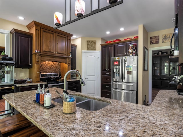 40 Briarwood Dr, Elkins, WV 26241 - kitchen with stainless steel appliances, a sink, light stone countertops, a kitchen bar, and recessed lighting