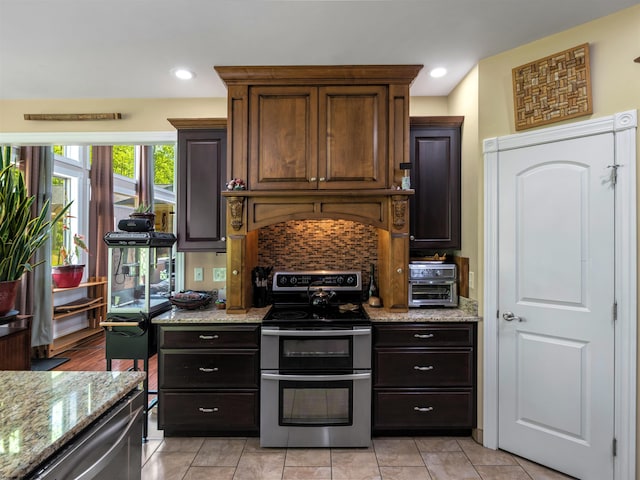 40 Briarwood Dr, Elkins, WV 26241 - kitchen with range with two ovens, tasteful backsplash, light stone countertops, recessed lighting, and custom range hood