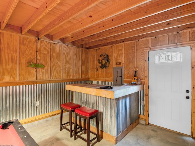 40 Briarwood Dr, Elkins, WV 26241 - indoor dry bar featuring unfinished concrete flooring, electric panel, and wood walls