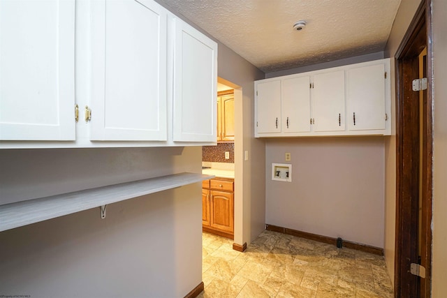 213 Forest Dr, Bridgeport, WV 26330 - washroom with cabinet space, hookup for a washing machine, baseboards, stone finish floors, and a textured ceiling