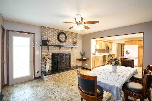 213 Forest Dr, Bridgeport, WV 26330 - dining room with ceiling fan, a fireplace, light stone finish floors, and baseboards
