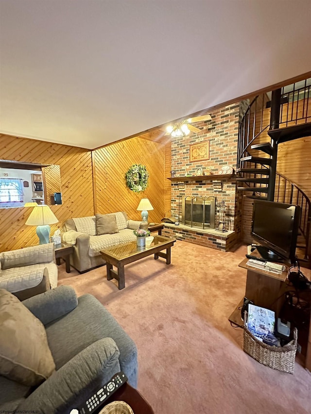1322 Crystal Lake Rd, West Union, WV 26456 - carpeted living area featuring a fireplace, wooden walls, ceiling fan, and stairway