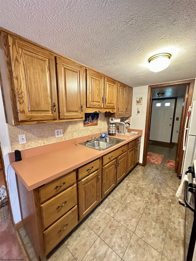 1322 Crystal Lake Rd, West Union, WV 26456 - kitchen featuring a sink, brown cabinets, decorative backsplash, and a textured ceiling